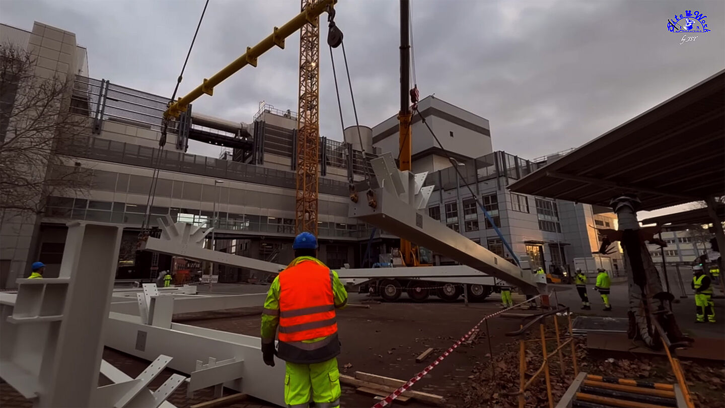 Bauarbeiter installieren eine Stahlkonstruktion auf einer Baustelle.